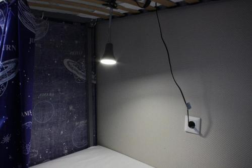 a corner of a room with a light on the wall at Hostel on Universytet in Kyiv