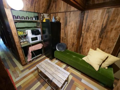 a living room with a green couch and a table at Villa Sacra in Kamakura