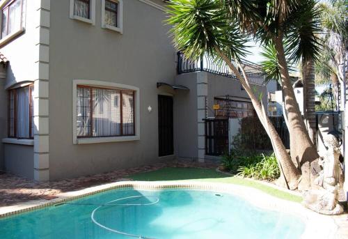a house with a swimming pool in front of a house at Entire Self catering Home in Springs in Springs