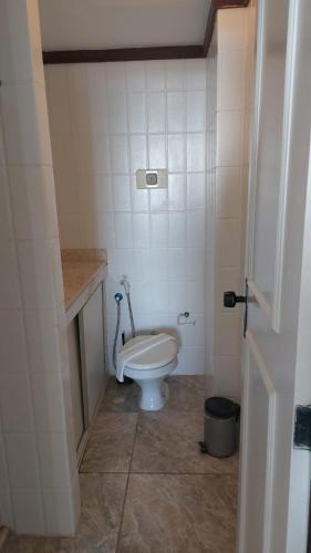 a small bathroom with a toilet in a room at Ondina Atlantic City in Salvador