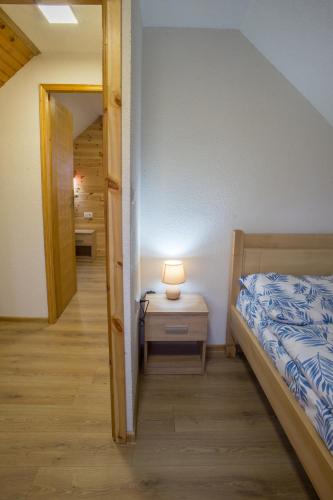 a bedroom with a bed and a lamp on a table at Fenix in Žabljak