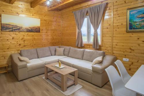 a living room with a couch and a table at Fenix in Žabljak
