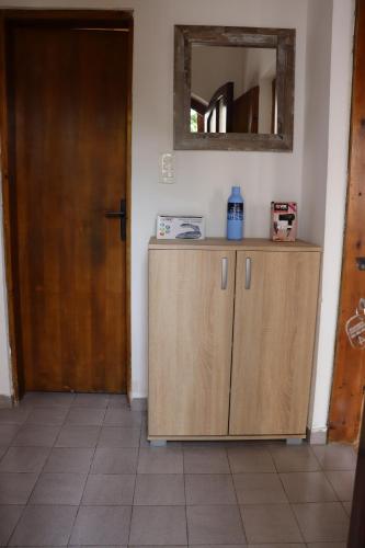 a room with a wooden cabinet and a mirror at Apartments Radulovic in Sutomore