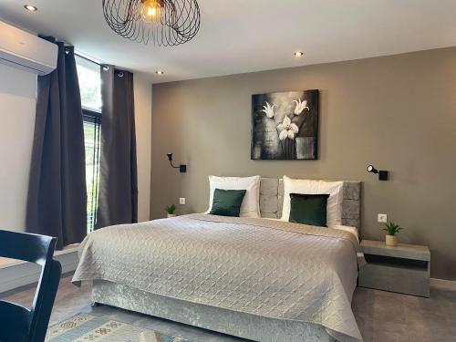 a bedroom with a large bed with green pillows at Hotel De Dampoort in Middelburg