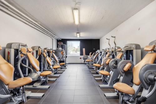 a gym with rows of exercise bikes and treadmills at Bruksgården Bed&Breakfast in Undenäs