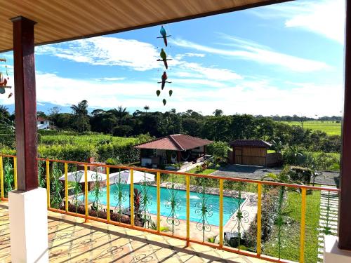 a view from the balcony of a house with a swimming pool at Casa Campestre Denis in Guamal