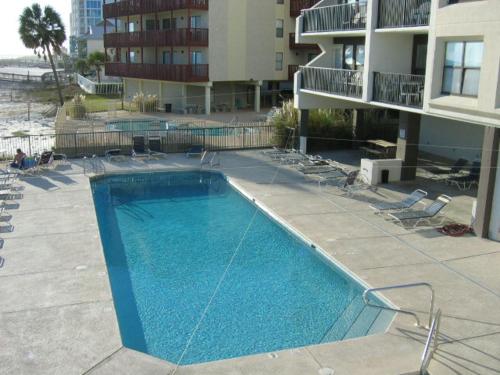 a large swimming pool in front of a building at Island Winds West 875 by ALBVR - Upgraded Beachfront Condo - Fantastic Location in Gulf Shores