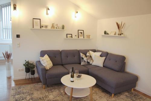 a living room with a couch and a table at Chiemsee Apartments in Altenmarkt an der Alz