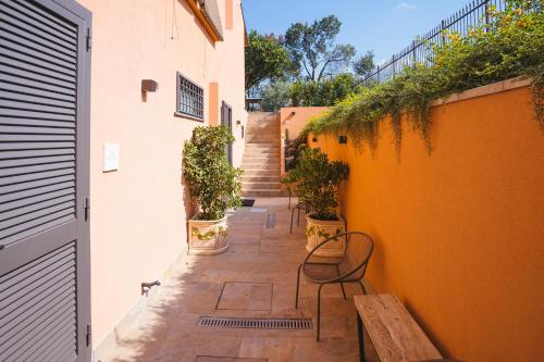 a patio with chairs and stairs in a building at Le Monachelle Luxury in Eboli