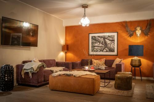 a living room with a couch and a table at Skåbu Fjellhotell in Skåbu