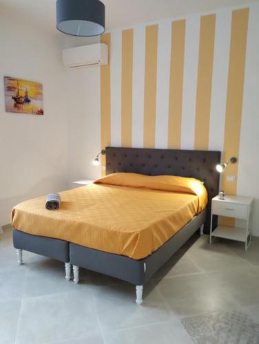 a bedroom with a bed with a orange bedspread at Monti d'aMare in Agerola