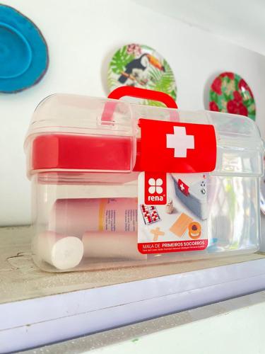 a plastic container filled with medicines on a shelf at Quarto Nº7 FAMILIA VEIGA - Central Praia in Praia