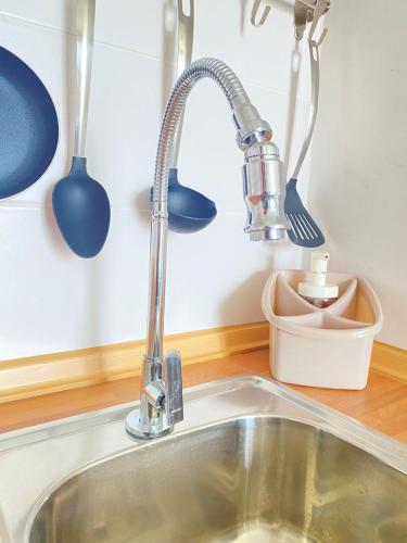 a kitchen sink with a kitchen faucet at Quarto Nº7 FAMILIA VEIGA - Central Praia in Praia