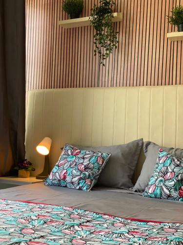 a bed with two pillows on it in a room at Quarto Nº7 FAMILIA VEIGA - Central Praia in Praia