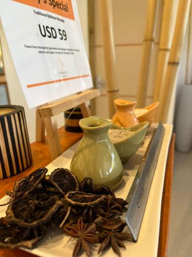 a plate with a vase and spices on a table at Wish Guesthouse in Huraa
