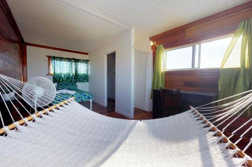 a room with two hammocks in a house at The French Lady Guest House - Entire House in Caye Caulker