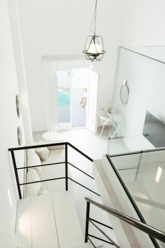 a room with white walls and a glass floor at Cavo Bianco Boutique Hotel & Spa in Kamari
