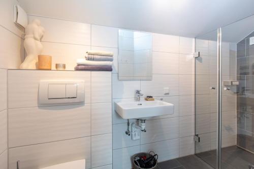 a bathroom with a sink and a shower at Landhaus Widlroither in Mondsee