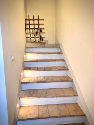 a set of stairs in a room with lights at Birillo 1824 in Poggibonsi