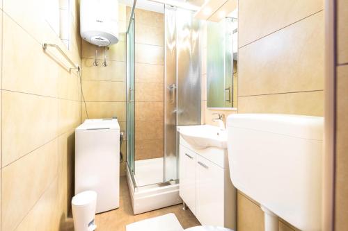 a bathroom with a toilet and a sink and a shower at Ogi Seaside Gajac in Novalja