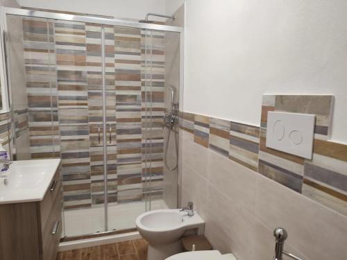 a bathroom with a shower and a toilet and a sink at TRAPANI CITY SEA APARTMENT in Trapani