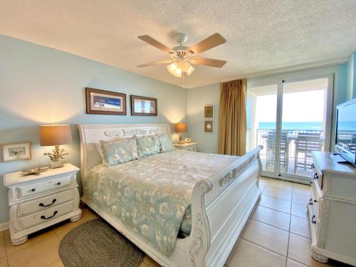 a bedroom with a bed and a ceiling fan at Wind Drift 102S by ALBVR - 2BR, 2BA Beautiful Upgraded Beachfront Condo near Flora Bama, Outdoor Pools and Tennis Courts in Orange Beach