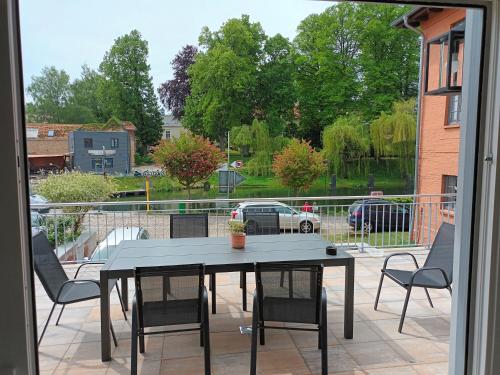 a table and chairs on a patio with a view at Constanza in Plau am See
