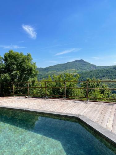 a swimming pool with a view of a mountain at Chiesa Ignano 1778 in Marzabotto