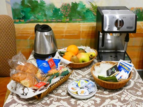 a table with two baskets of food and a coffee maker at Valverde in Cengio