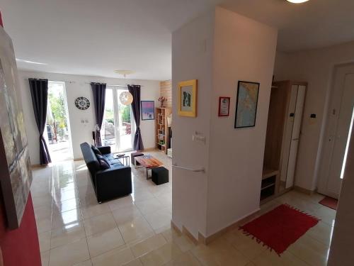 a living room with a couch and a chair at The Forest House Krk 1 in Kras