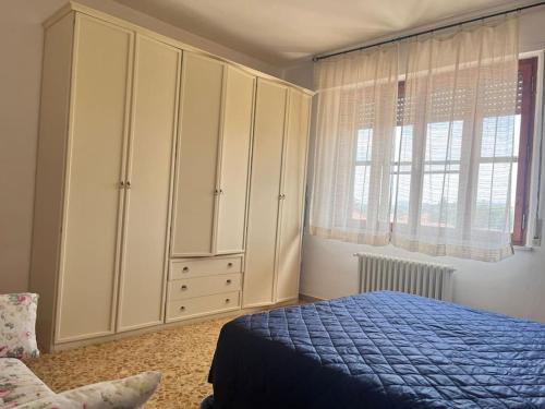 a bedroom with a blue bed and a large cabinet at Vacanze da Susy sul lago Trasimeno in Passignano sul Trasimeno