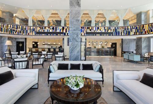 a lobby with couches and a table with flowers on it at Medi Terre Boutique Hotel - By Saida Hotels in Netanya