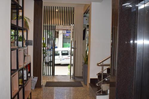 a hallway with a door leading into a building at Hotel New Centro in Gulbarga