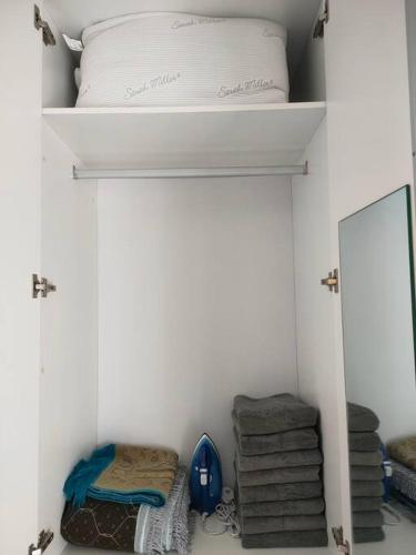 a closet with a bed and a mirror and towels at MyHome S1 At Seri Kembangan With A View in Seri Kembangan