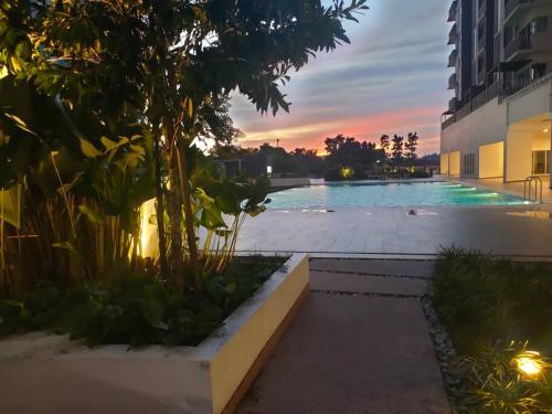 a swimming pool with a sunset in the background at MyHome S1 At Seri Kembangan With A View in Seri Kembangan