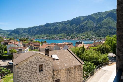 a view of a town with a river and mountains at C Group apartments in Kotor