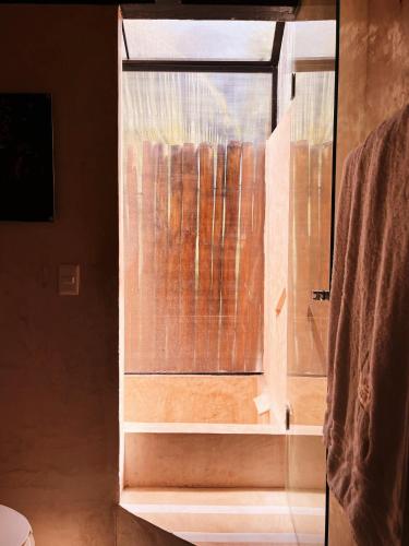 a window in a bathroom with a shower at Xtambaa Cabins & Spa Only Adults in El Cuyo