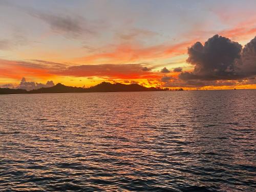 a sunset over a large body of water at Seaward in Koror