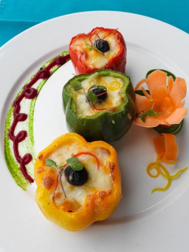 a plate of food with peppers and vegetables on it at Maru Maru Hotel in Zanzibar City