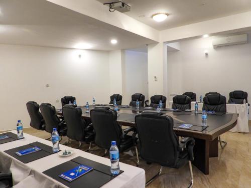 a conference room with tables and chairs and water bottles at Maru Maru Hotel in Zanzibar City