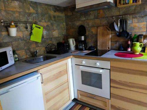 a kitchen with a sink and a counter top at Gites de Fouard "l Estancòt" in Malaurier