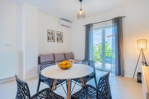 a living room with a table and chairs and a couch at Apartments Ivanka Cres in Cres