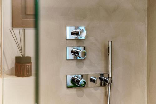 a door with three knobs on a wall at Suite Lo Storico - The House Of Travelers in Como