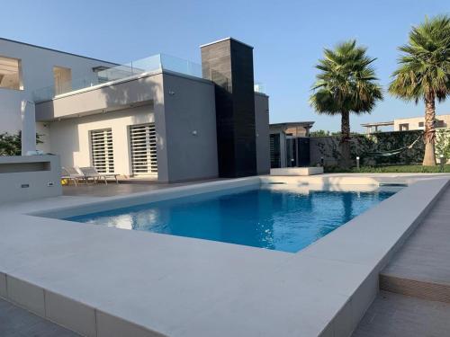 a swimming pool in front of a house at Casa vacanze in Volla