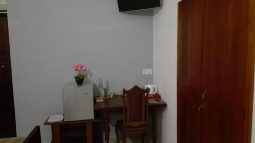 a room with a table and chairs and a room with a door at Crescent N Cocoon in Ambalangoda