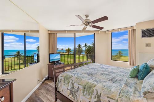 a bedroom with a bed and a ceiling fan at Kauhale Makai 535 in Kihei