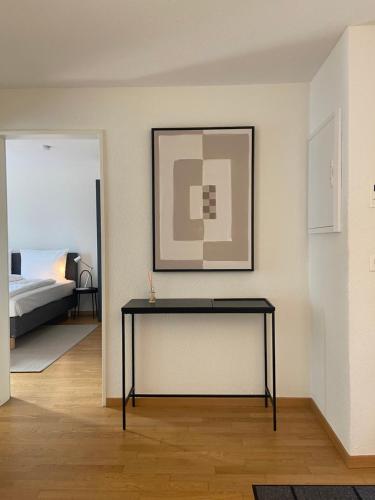 einen schwarzen Tisch in einem Zimmer mit einem Bett in der Unterkunft 1 BDR Apartment in Zurich West in Zürich