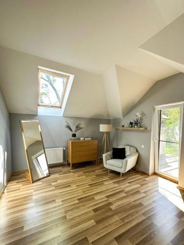 a living room with a skylight and wooden floors at Vilhelma Purvīša 27k.1 in Jūrmala