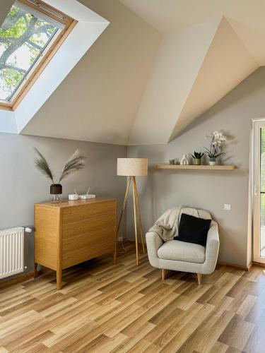 a living room with a skylight and a chair at Vilhelma Purvīša 27k.1 in Jūrmala