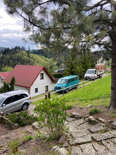 a group of cars parked in front of a house at Cerla Korbielów in Korbielów
